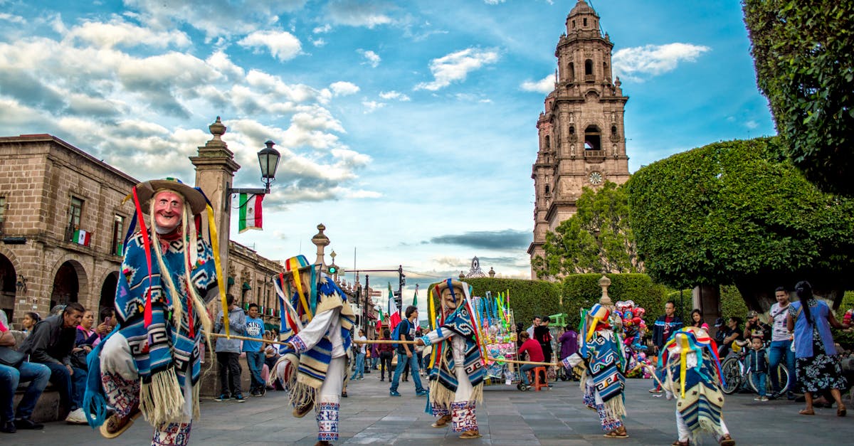 Colorful traditional dance performance at a Mexican festival in front of a historic church.